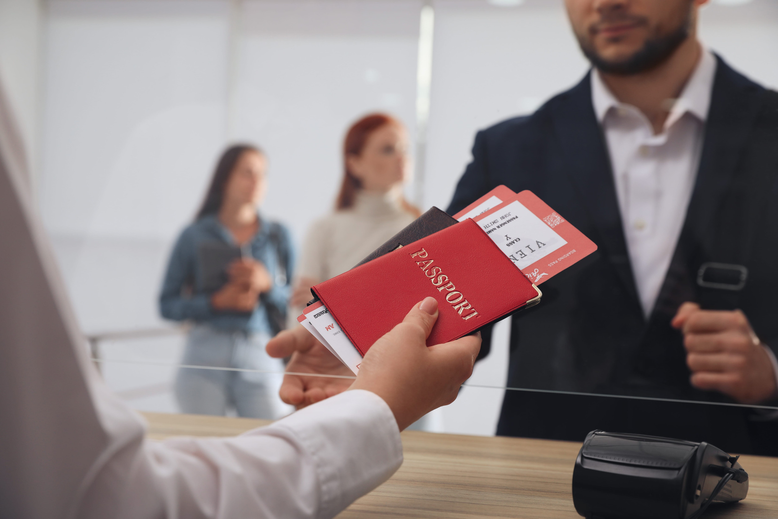 Agent Giving Passports To Client On Desk