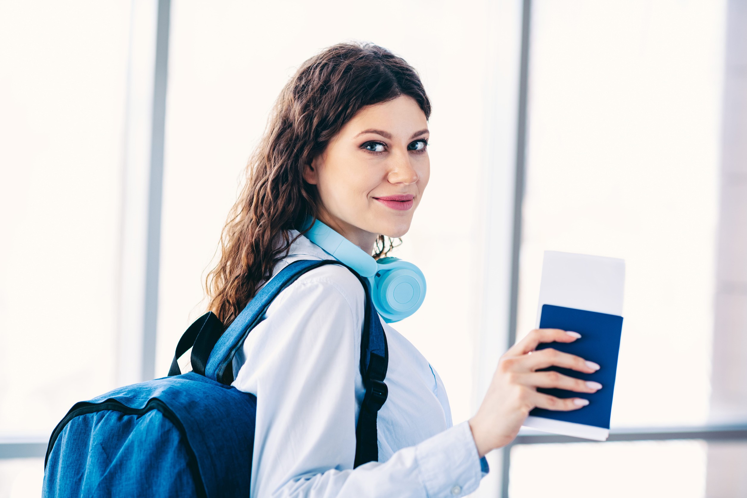 Charming Woman With Backpack Holding A Passport