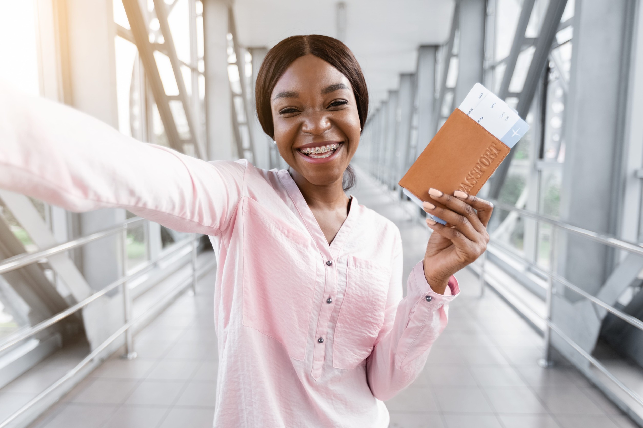 Excited Cheerful African Woman With Passport And Tickets