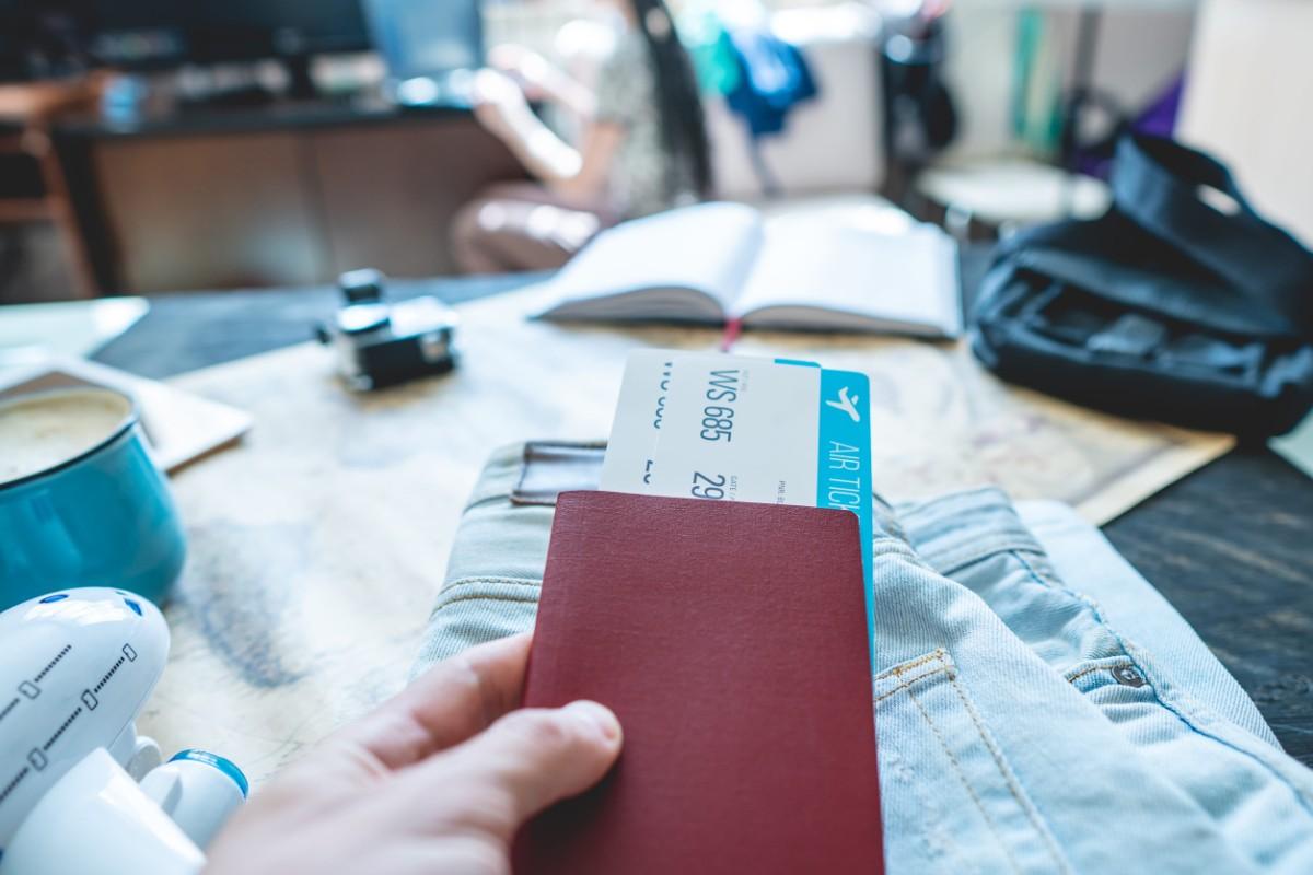 Hand Holding A Passport And Tickets