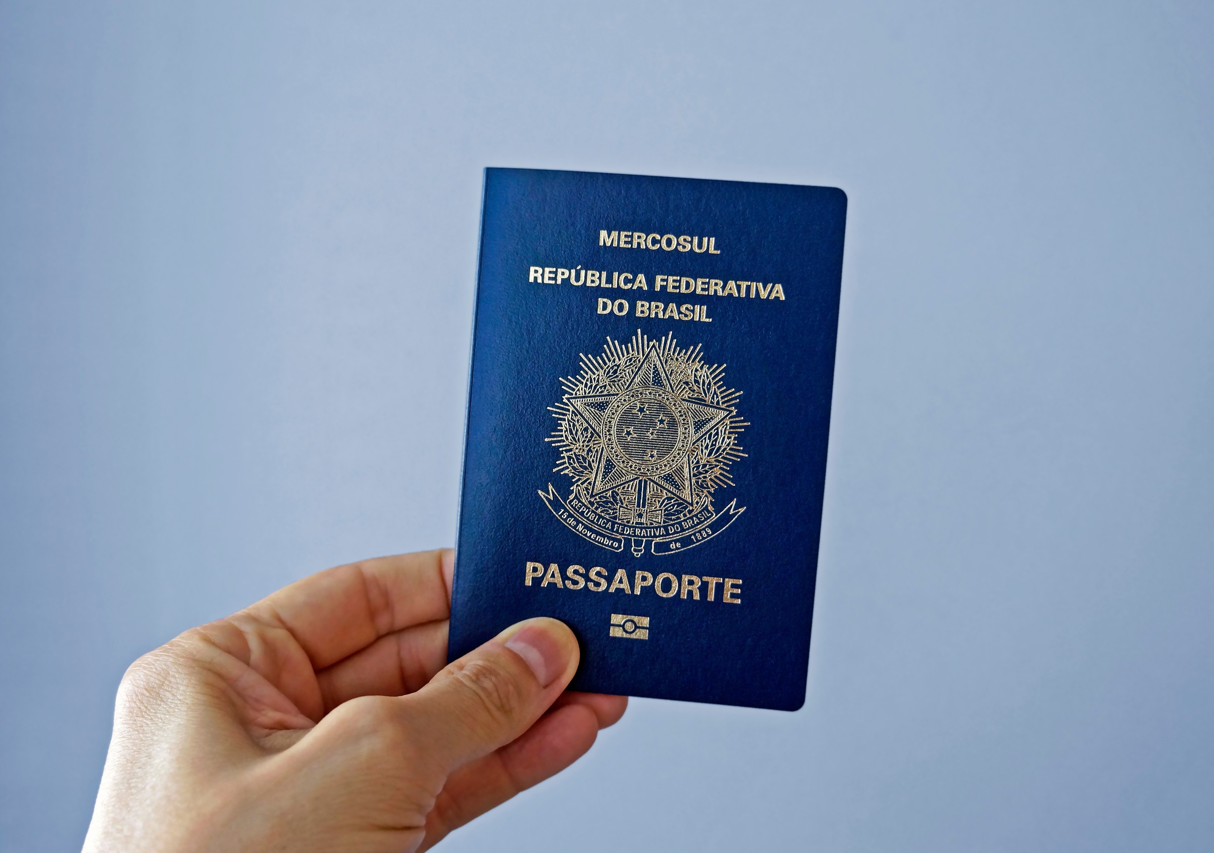 Hand Holding Brazilian Passport