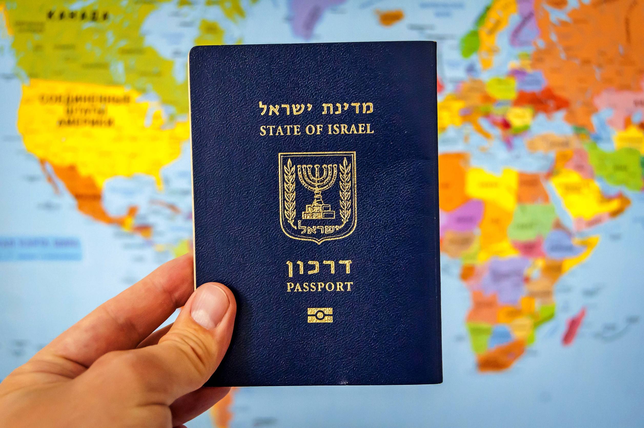 Hand Holding The Passport Of Israel