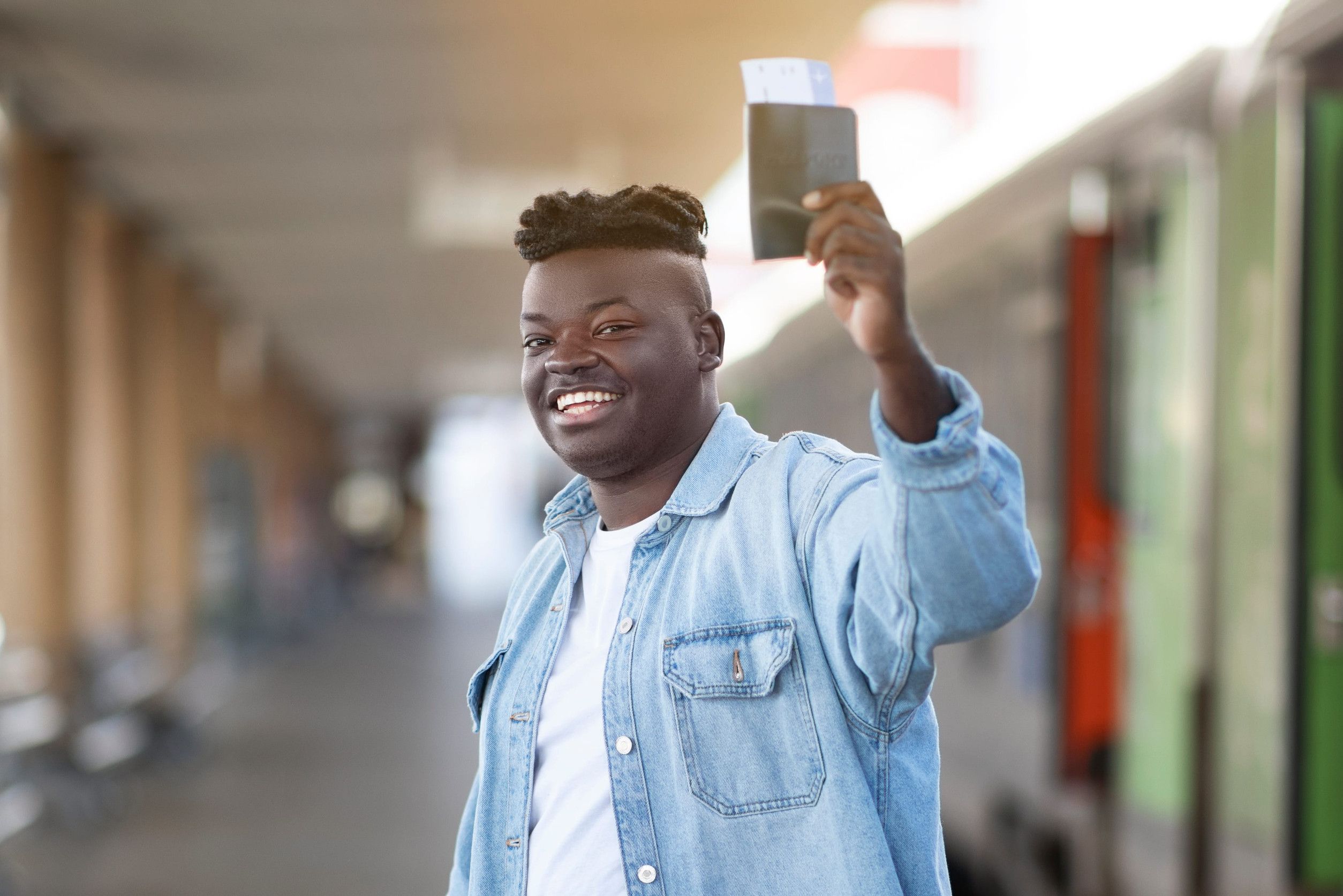 Happy Young Black Guy Posing With Passport