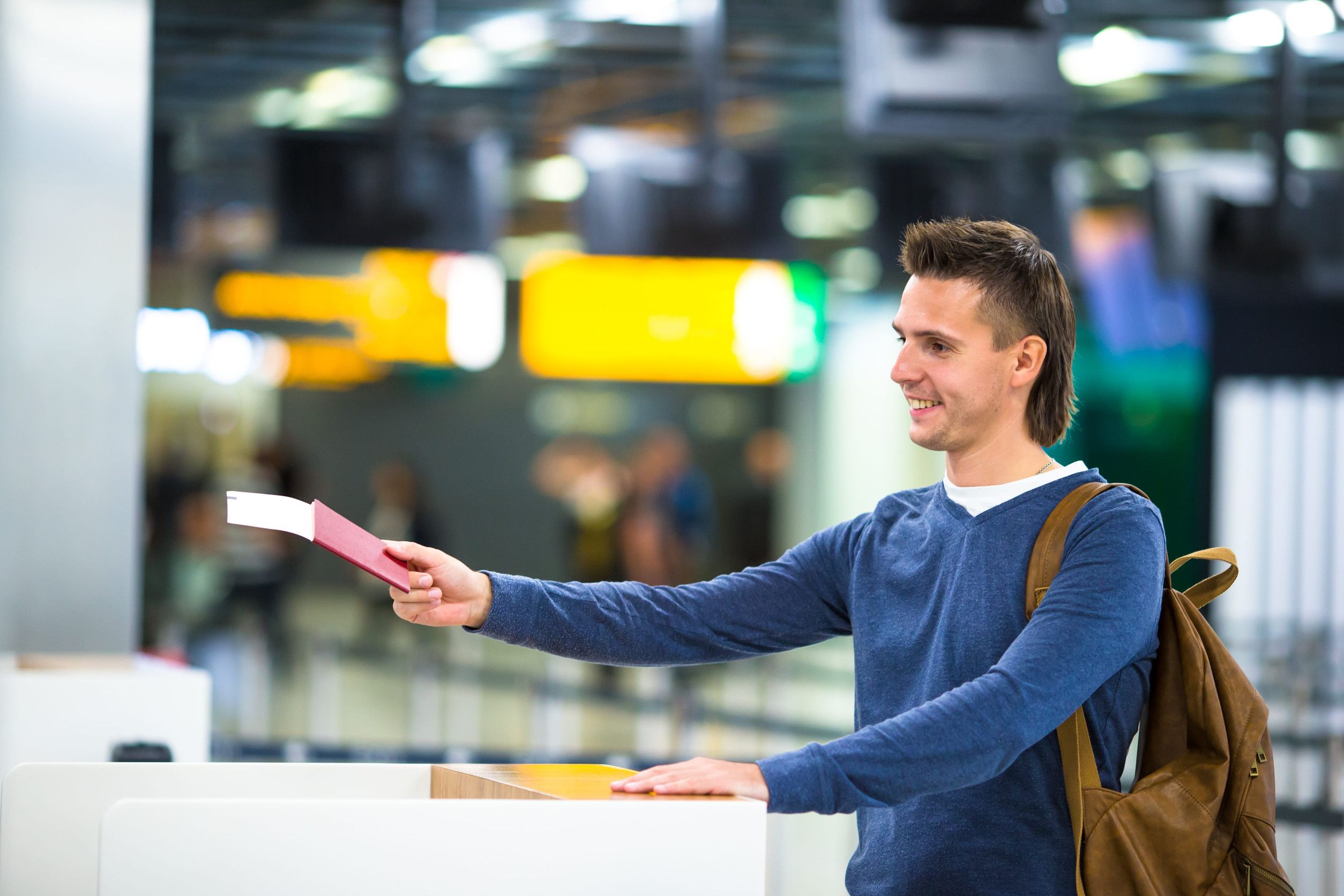 Male Holding Passport At Airport