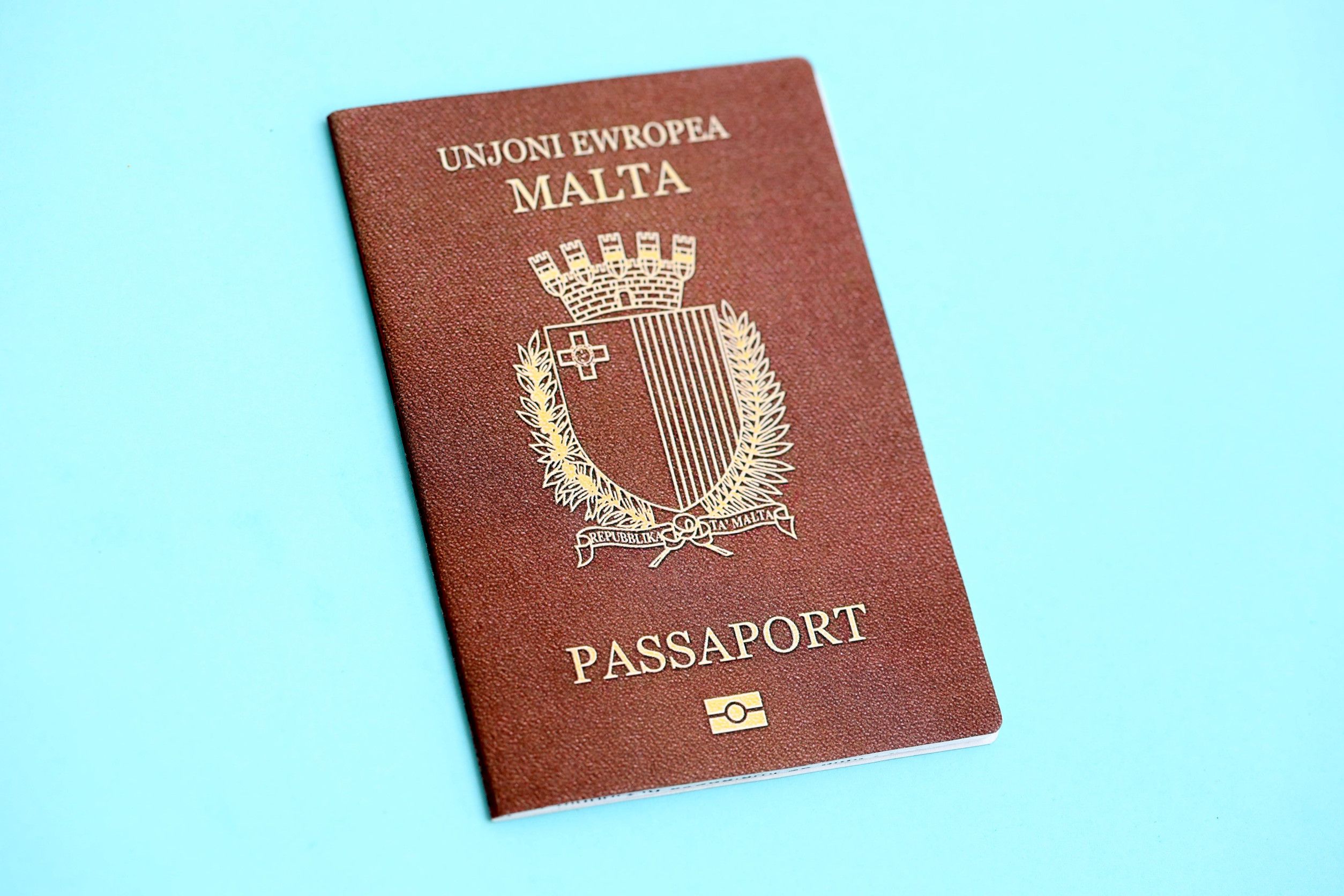 Malta Passport On Light Blue Paper