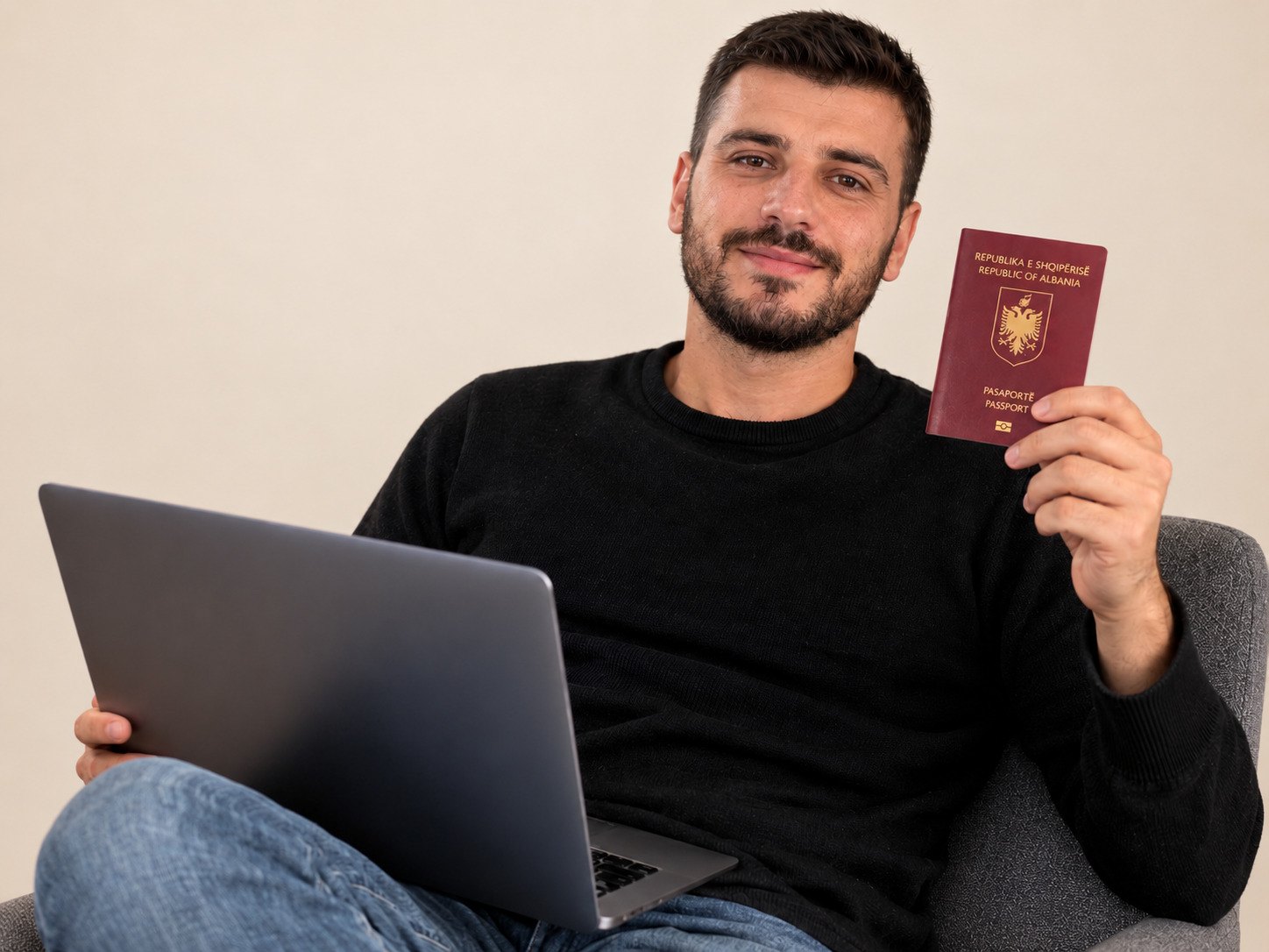 Man Holding A Passport And A Laptop