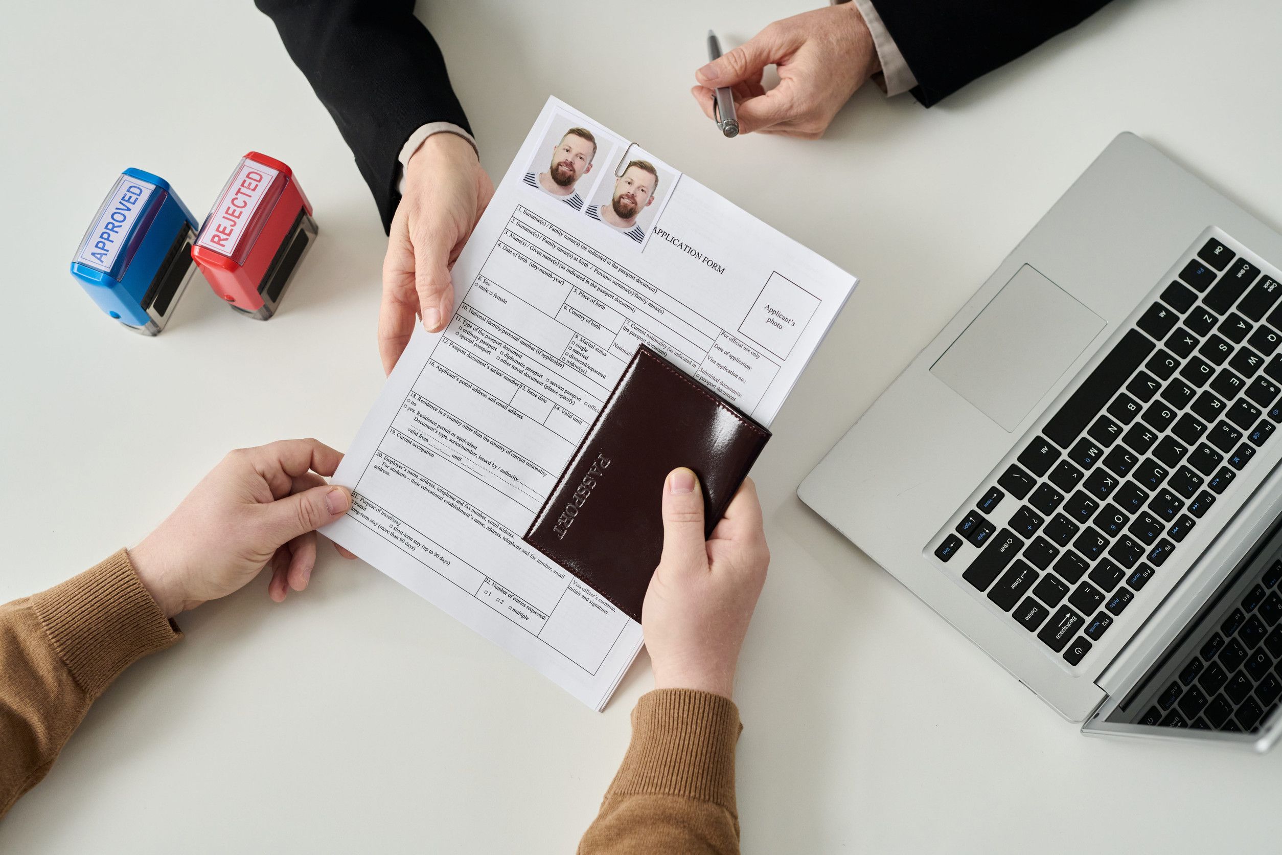 Man Submitting Visa Documents At Immigration Office