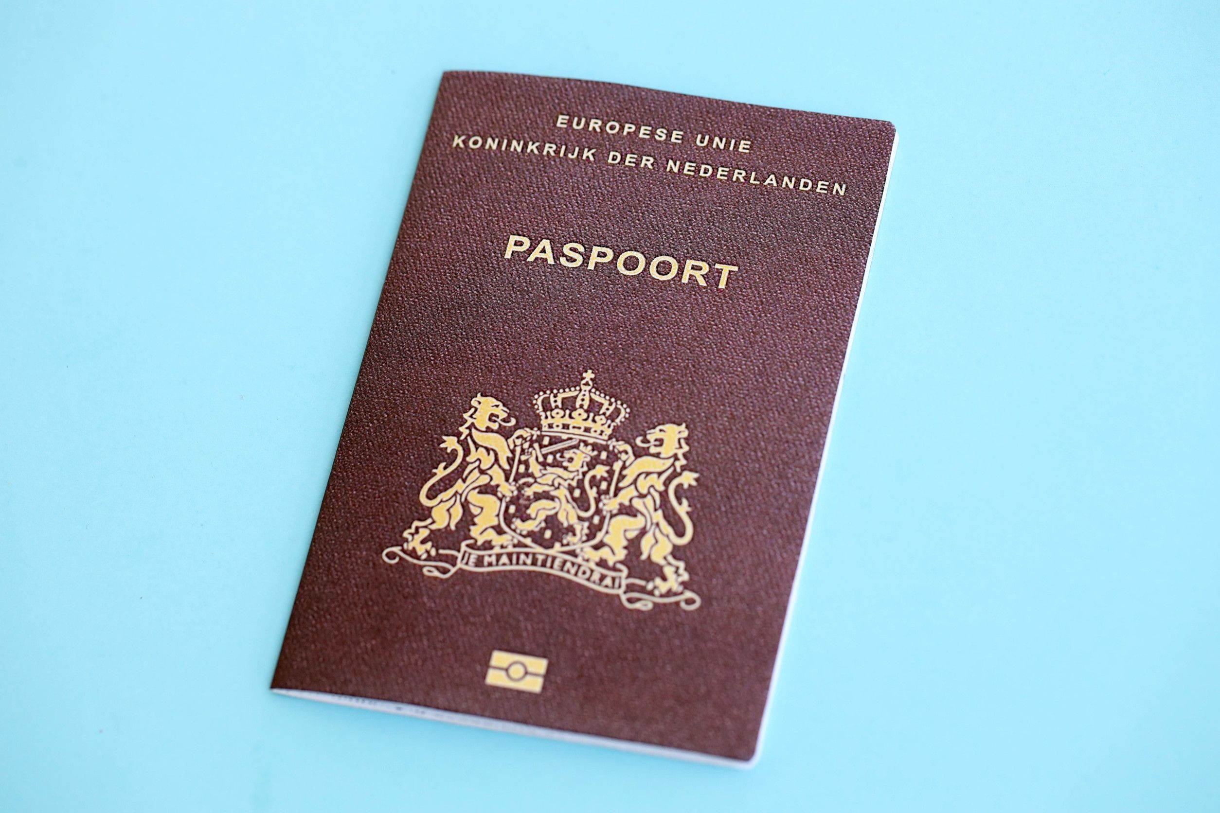Netherlands Passport On Light Blue Paper Background