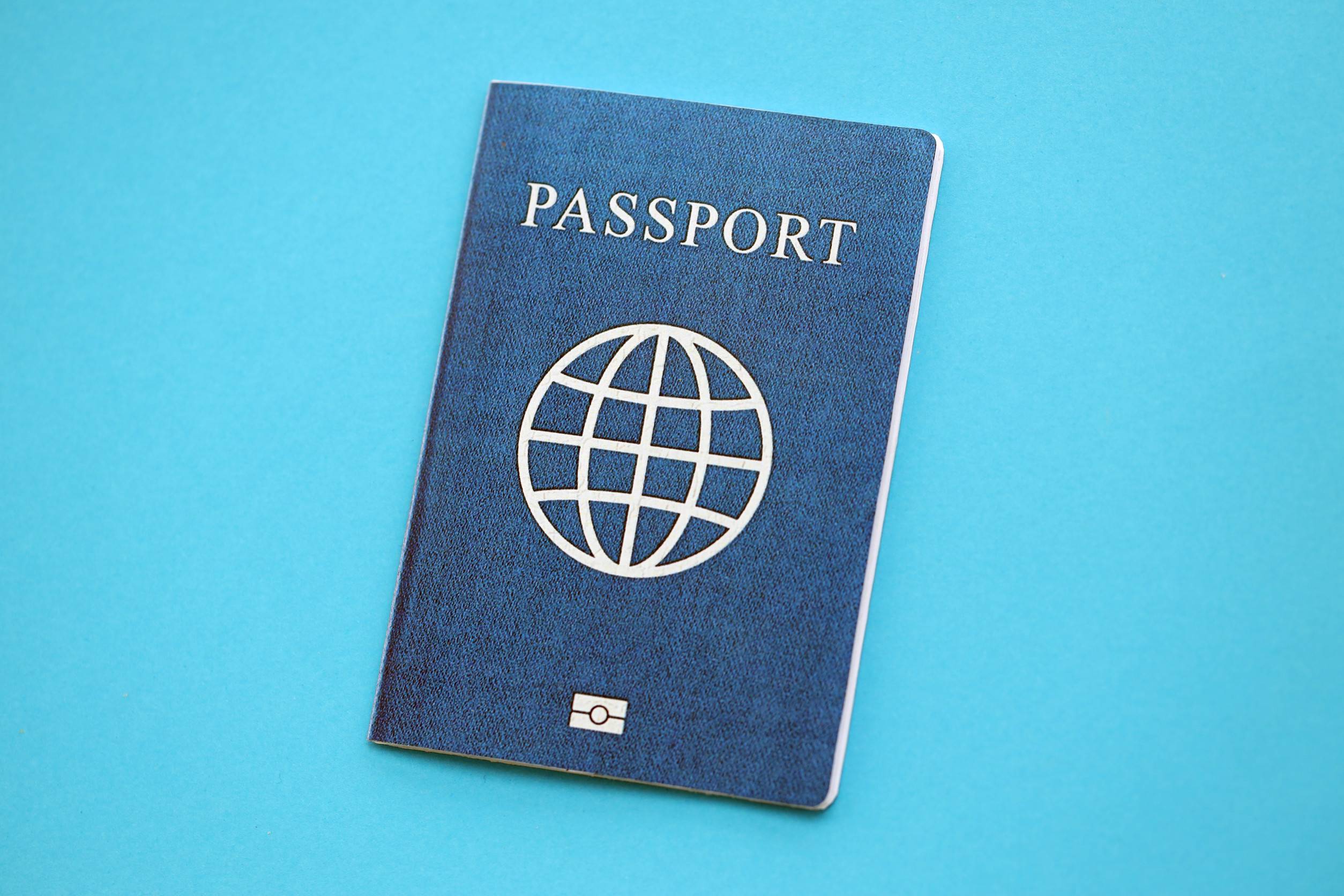 Passport Book On Light Blue Paper Background