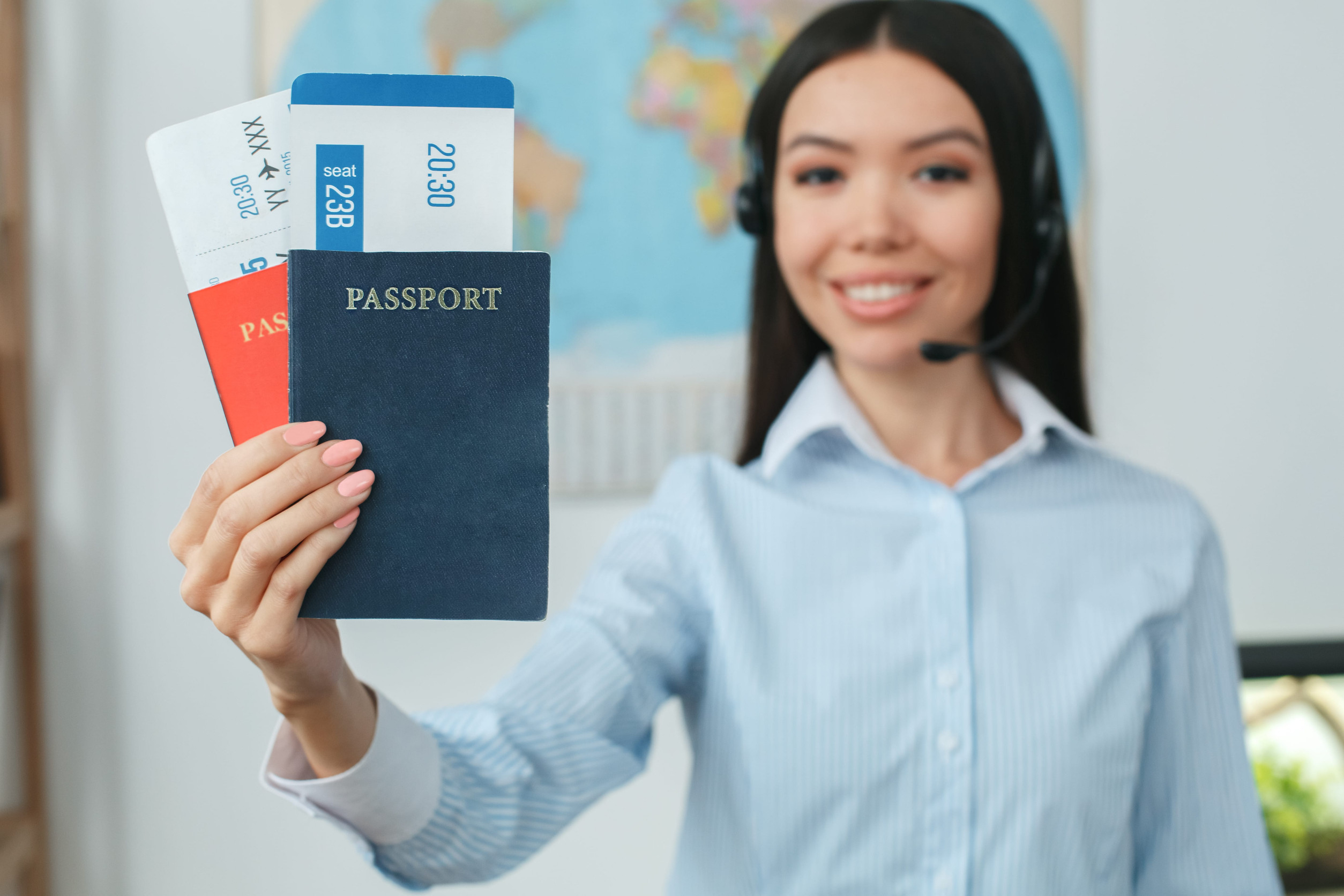 Young Female Travel Agent Showing Passport