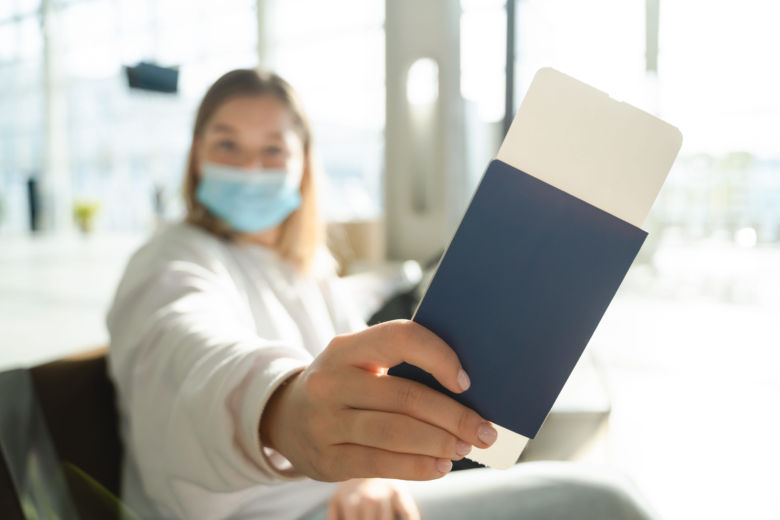Young Woman Shows Her Passport To The Camera